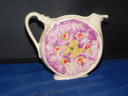 Small, cream-colored pitcher with a round body